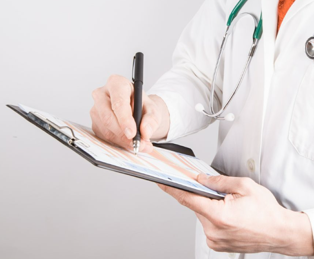 Doctor writing notes on a clipboard